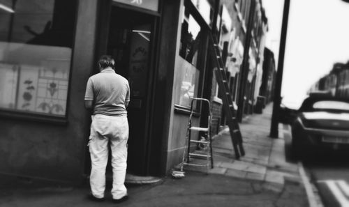 Close-up of woman standing against wall