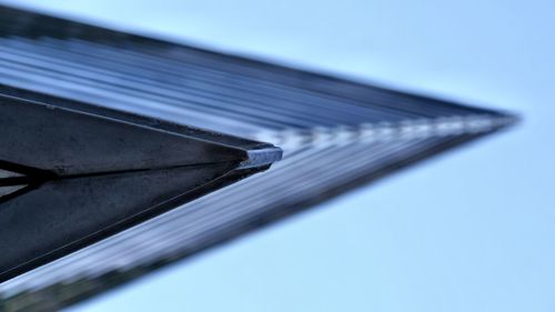 Low angle view of metallic structure against blue sky