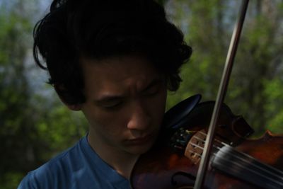 Close-up of man playing violin