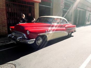 Red vintage car on city street