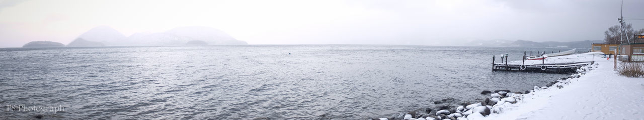 Scenic view of sea against sky during winter