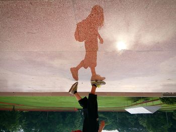 Upside down image of girl reflection on floor