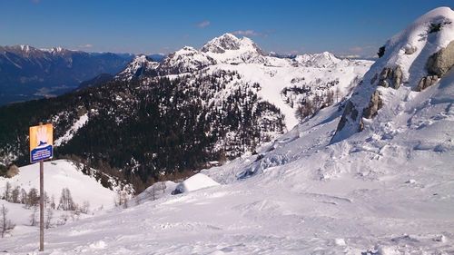 Scenic view of snow covered mountains against sky