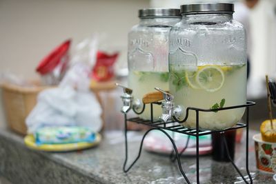 Close-up of lemonade in glass jars on table