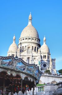 Low angle view of montmartre against blue sky