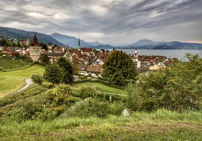 Panoramic view of townscape and mountains against sky