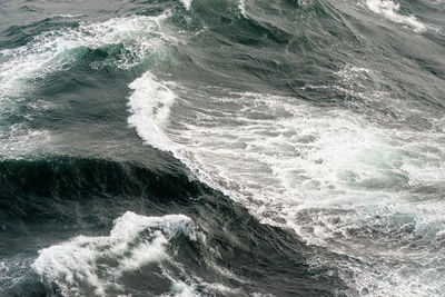 High angle view of waves splashing in sea