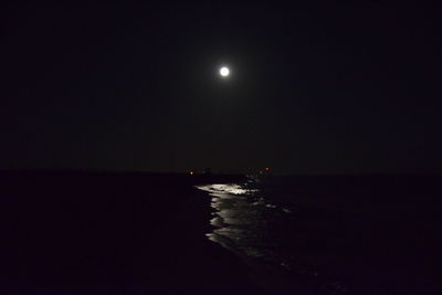 Scenic view of sea against moon at night