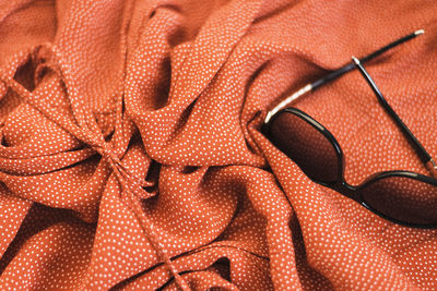 Close-up of sunglasses on red fabric