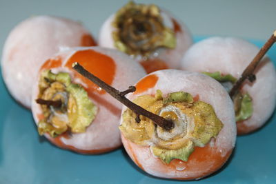 Close-up of persimmons in plate