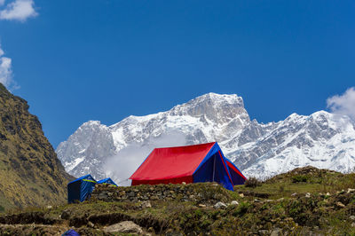 Scenic view of snowcapped mountains against blue sky