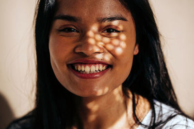 Close-up portrait of a smiling young woman