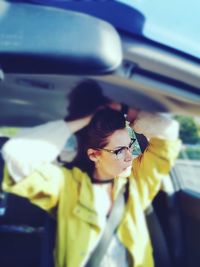 Close-up portrait of young woman in car