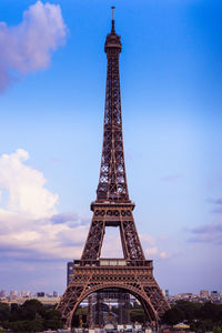 Communications tower against cloudy sky