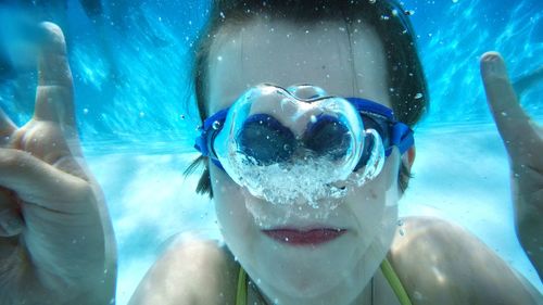 Portrait of girl swimming in pool