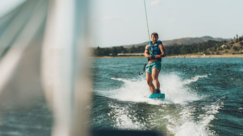 Full length of man wakeboarding in sea