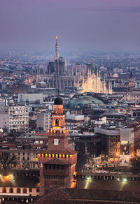 Aerial view of city lit up at night