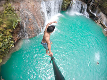 High angle view of man surfing in sea