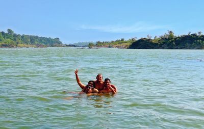 Portrait of friends enjoying at lake