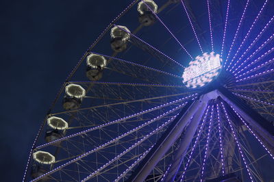 Low angle view of ferris wheel against sky at night