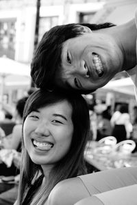 Portrait of cheerful young couple sitting outdoors