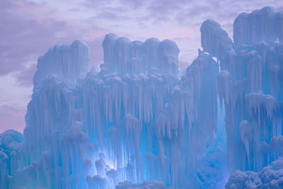 Close-up of icicles against sky