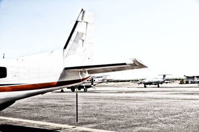 Airplane on airport runway against clear sky