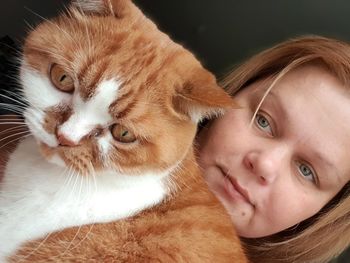 Close-up portrait of teenage girl with cat