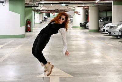 Full length portrait of woman in a parking lot