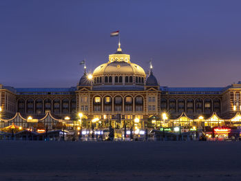 Illuminated building against sky at night