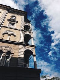 Low angle view of building against cloudy sky