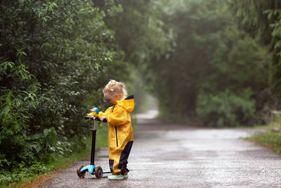 Side view of a boy walking on road