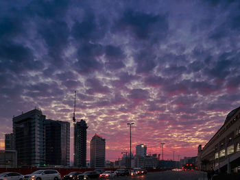 View of buildings against cloudy sky during sunset