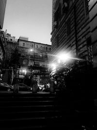 Low angle view of illuminated buildings against sky at night