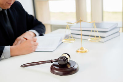 Close-up of man sitting on table