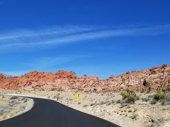 Scenic view of desert against clear blue sky