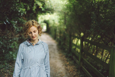 Young woman standing in forest