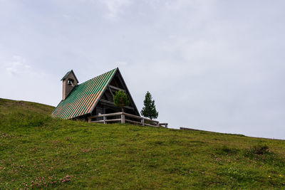 Built structure on field against sky