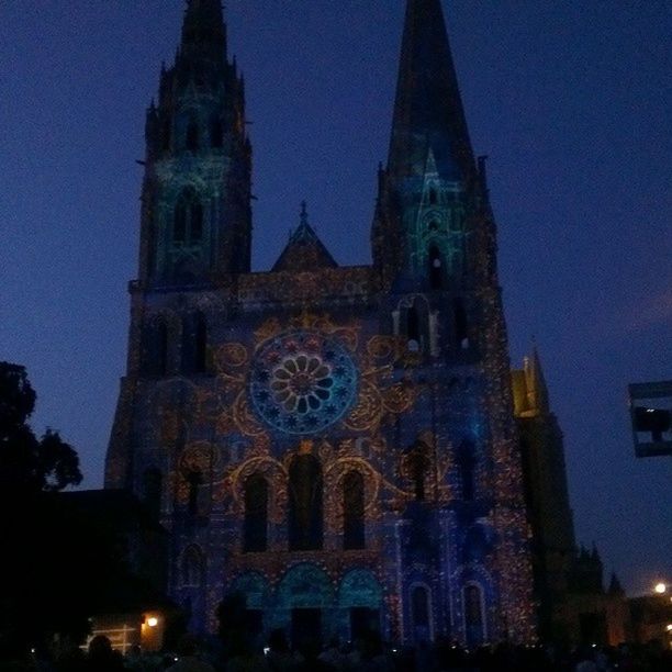 architecture, building exterior, religion, place of worship, church, built structure, spirituality, cathedral, low angle view, night, famous place, travel destinations, illuminated, history, sky, tourism, tower, clock tower