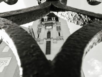 Low angle view of church against sky seen through railing