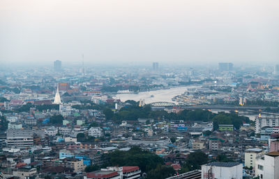 Aerial view landscape bangkok city and building along chaophraya river on evening, thailand