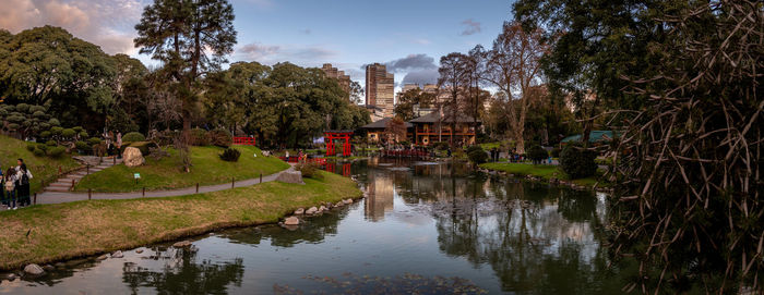 Reflection of trees and buildings in lake