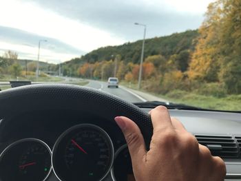 Close-up of hand on car windshield