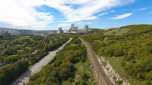 Panoramic shot of plants and buildings against sky