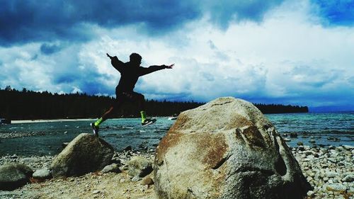 Silhouette of man jumping on beach