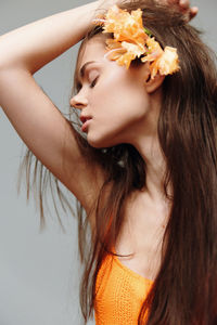 Close-up of young woman with flower