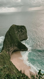 Scenic view of rocks on beach against sky