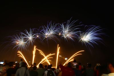 Low angle view of firework display at night