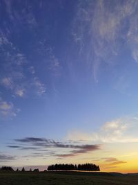 Scenic view of field against sky during sunset