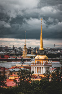 View of cityscape against cloudy sky